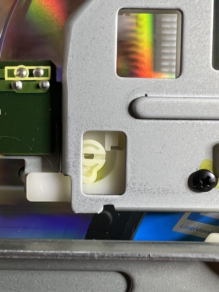 Image of the white and black screw used to adjust centering to avoid side B skipping